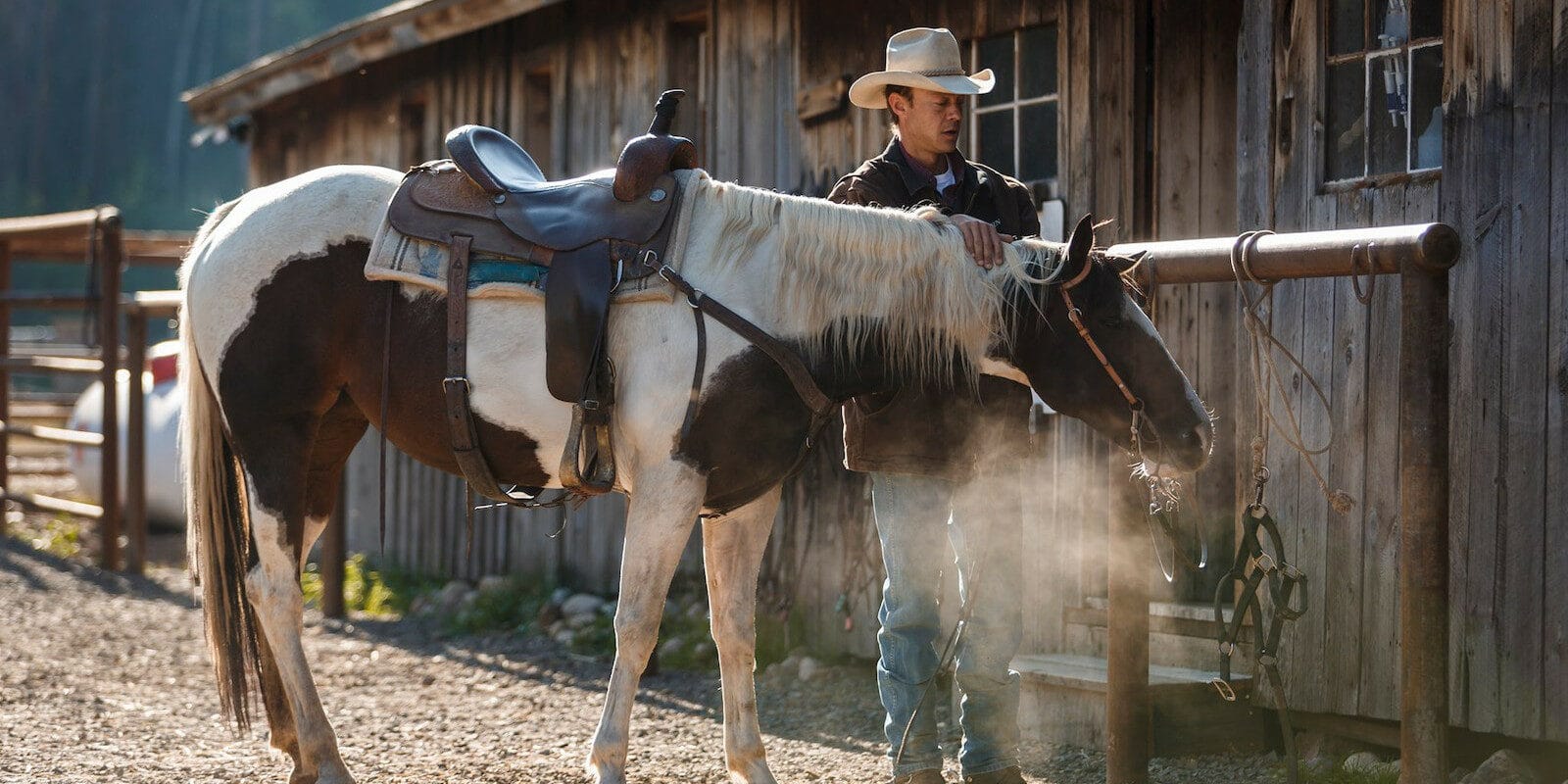 Image of a cowboy and his horse at the Rawah Guest Ranch in Colorado