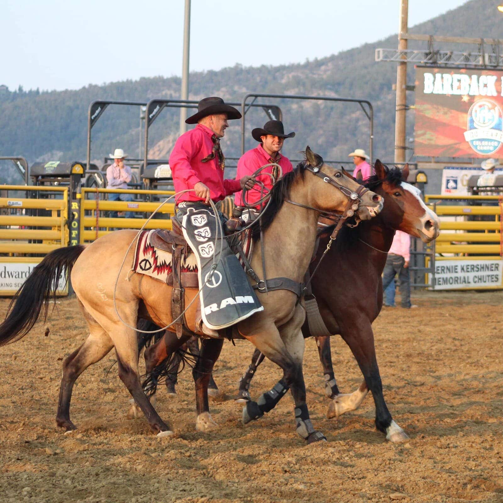 Image of cowboys on horses at the Rooftop Rodeo in Estes Park, Colorado