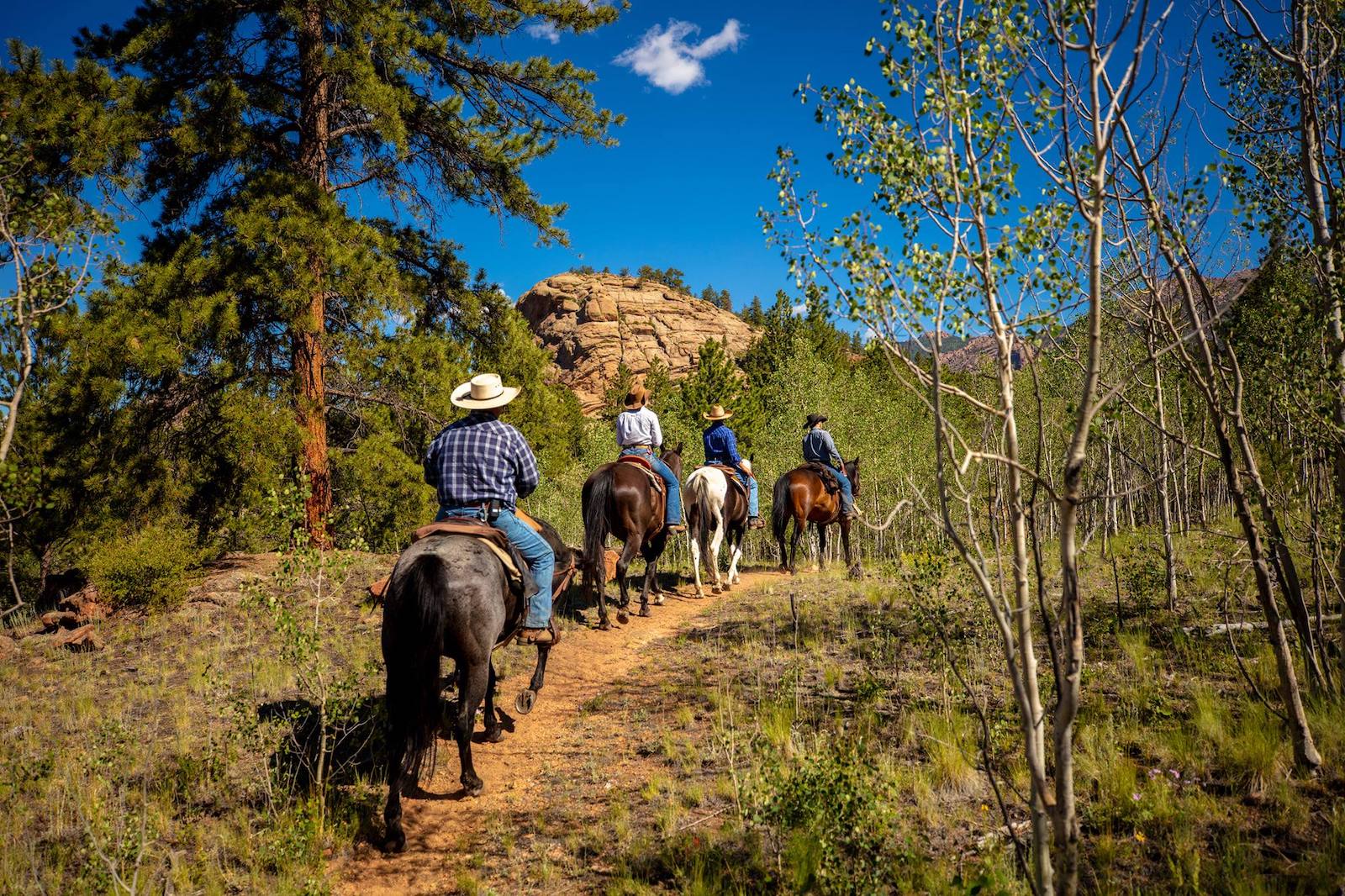 Image of people riding horses at Tarryall River Ranch in Lake George, Colorado