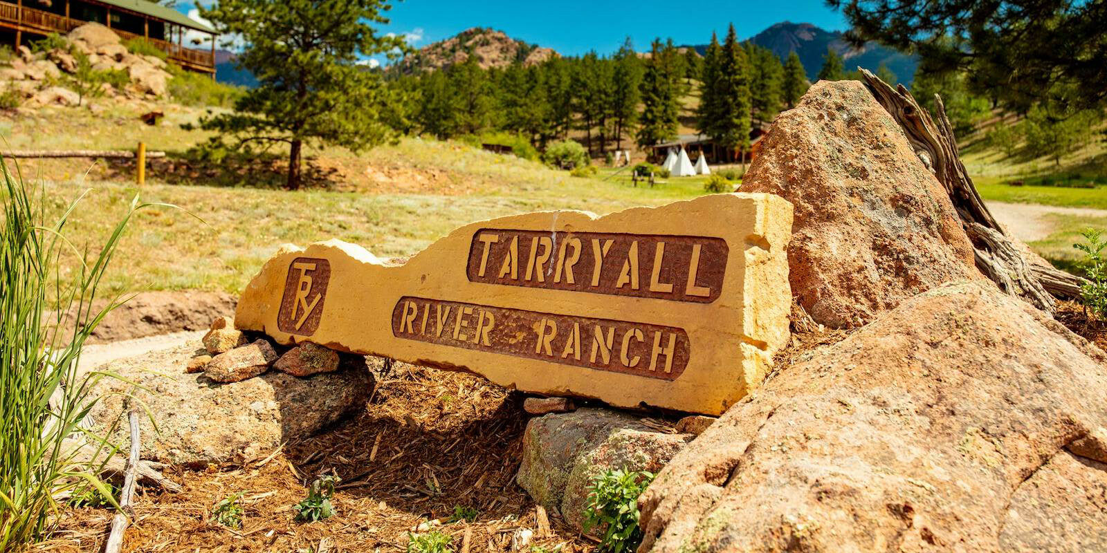 Image of a carved boulder with the logo for Tarryall River Ranch in Lake George, Colorado