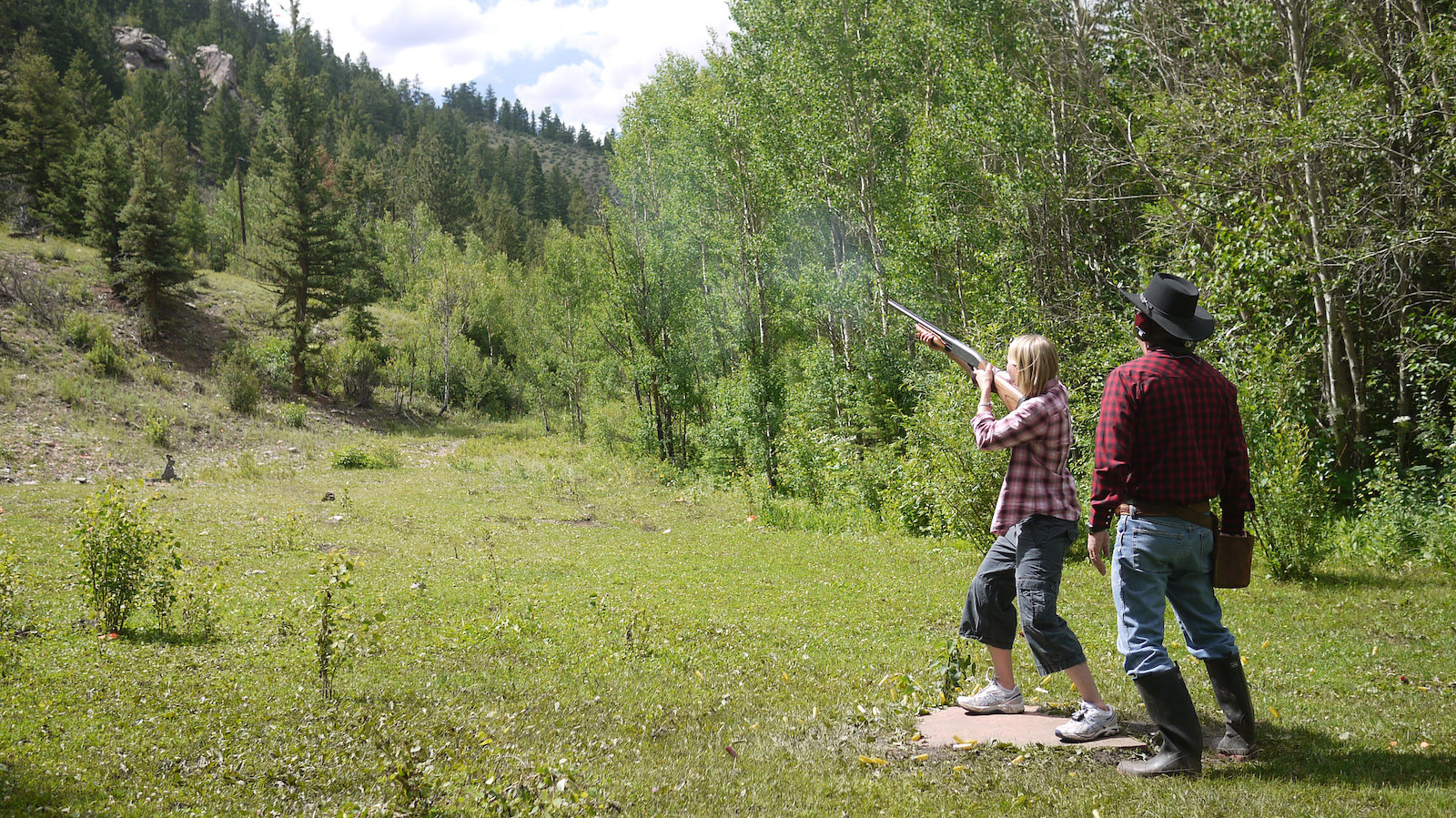 Image of a woman skeet shooting at Tumbling River Ranch in Grant, Colorado