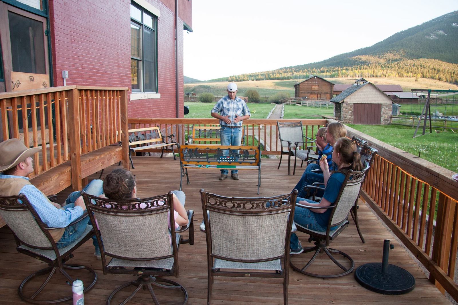 Image of people hanging out on the balcony at Waunita Hot Springs Ranch in Gunnison, Colorado