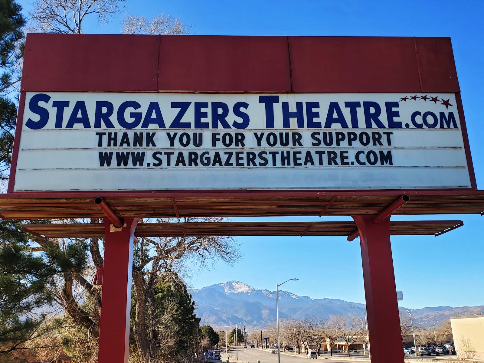 Image of a sign with the Stargazers Theatre website information