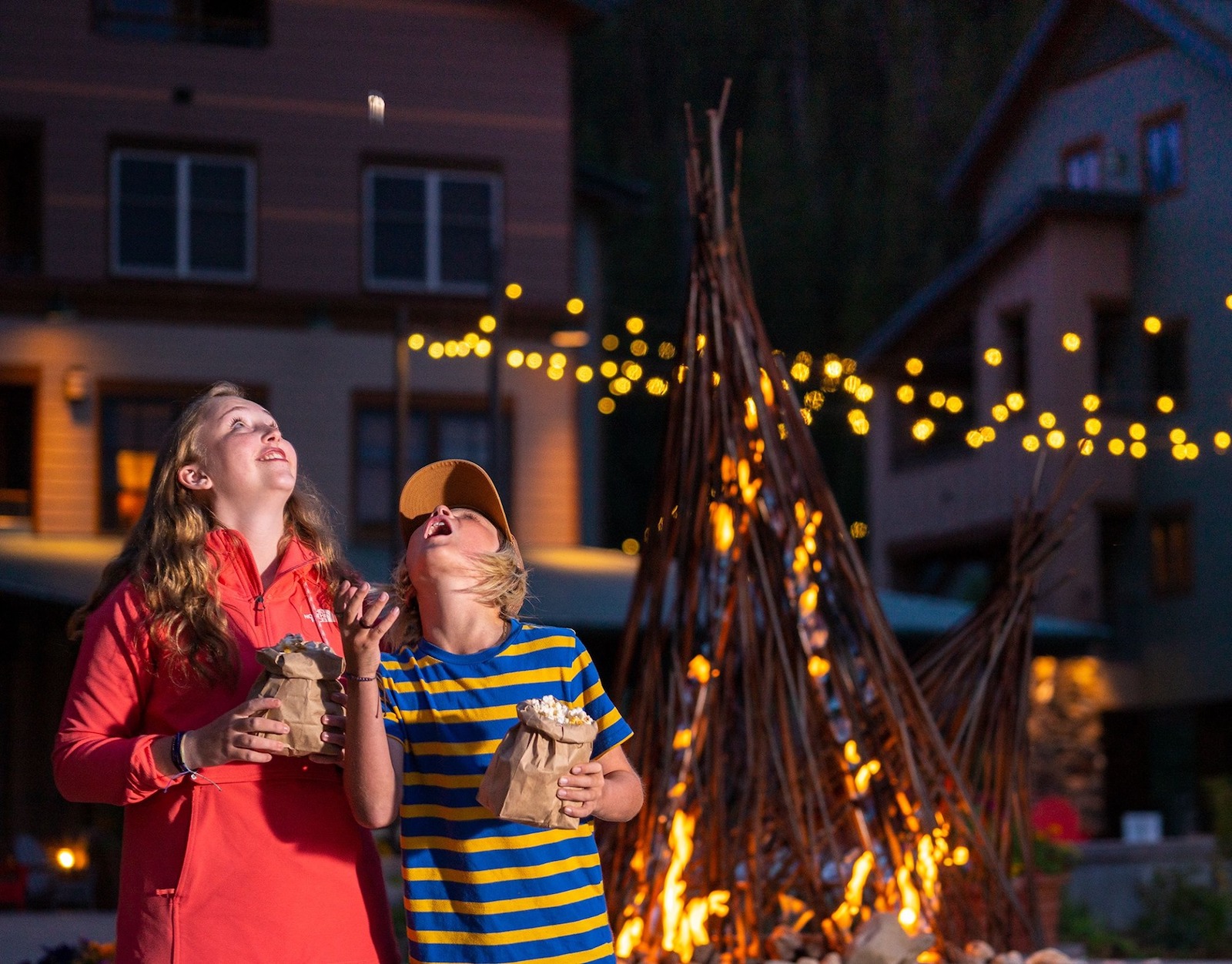 Image of kids next to a campfire looking at the stars at Winter Park Resort in Colorado