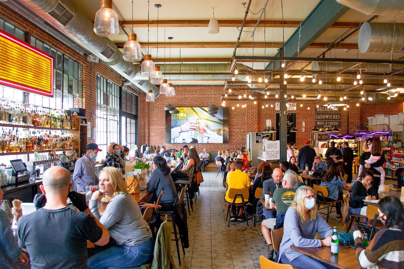 Image of people eating and drinking inside the Denver Central Market in Colorado