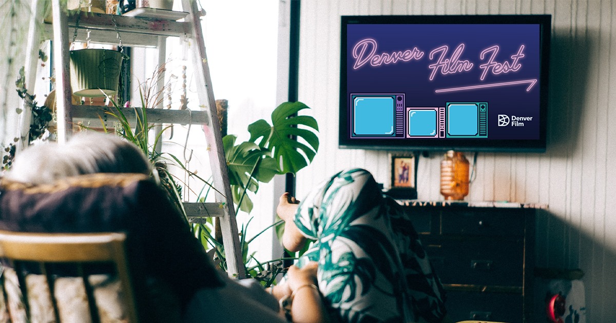 Image of a person looking at a TV with Denver Film Festival on it