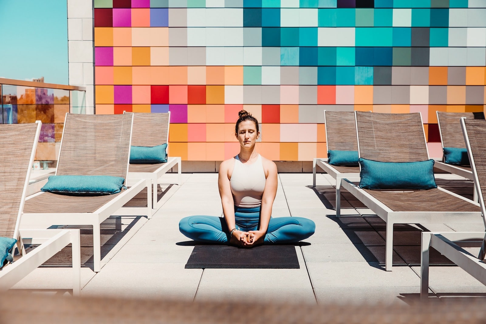 Image of a person doing yoga on the rooftop of Halcyon in Denver, Colorado