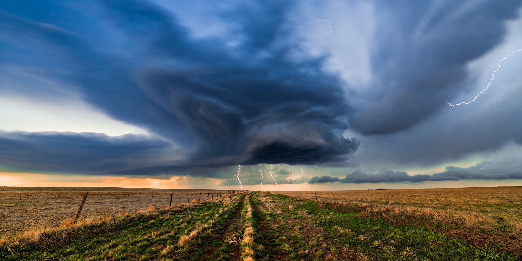 Dark storm clouds and lightning on the horizon.