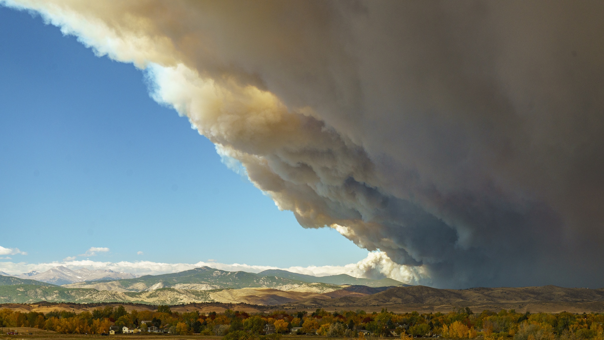 An enormous smoke plume from the East Troublesome Fire blankets parts of Northern Colorado.