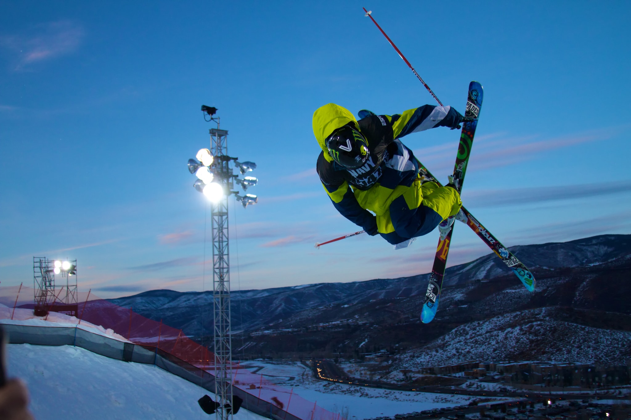 A skier in mid-air, crossing both skis in the shape of the letter X.