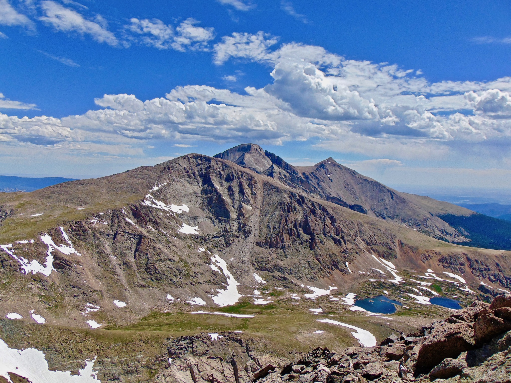 Blue skies and fluffy clouds above Longs Peak, Colorado.