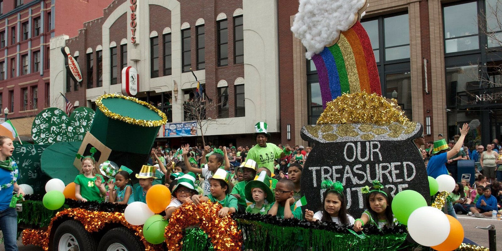 Image of a float with kids riding it at the Colorado Springs St. Patrick's Day Parade in Colorado