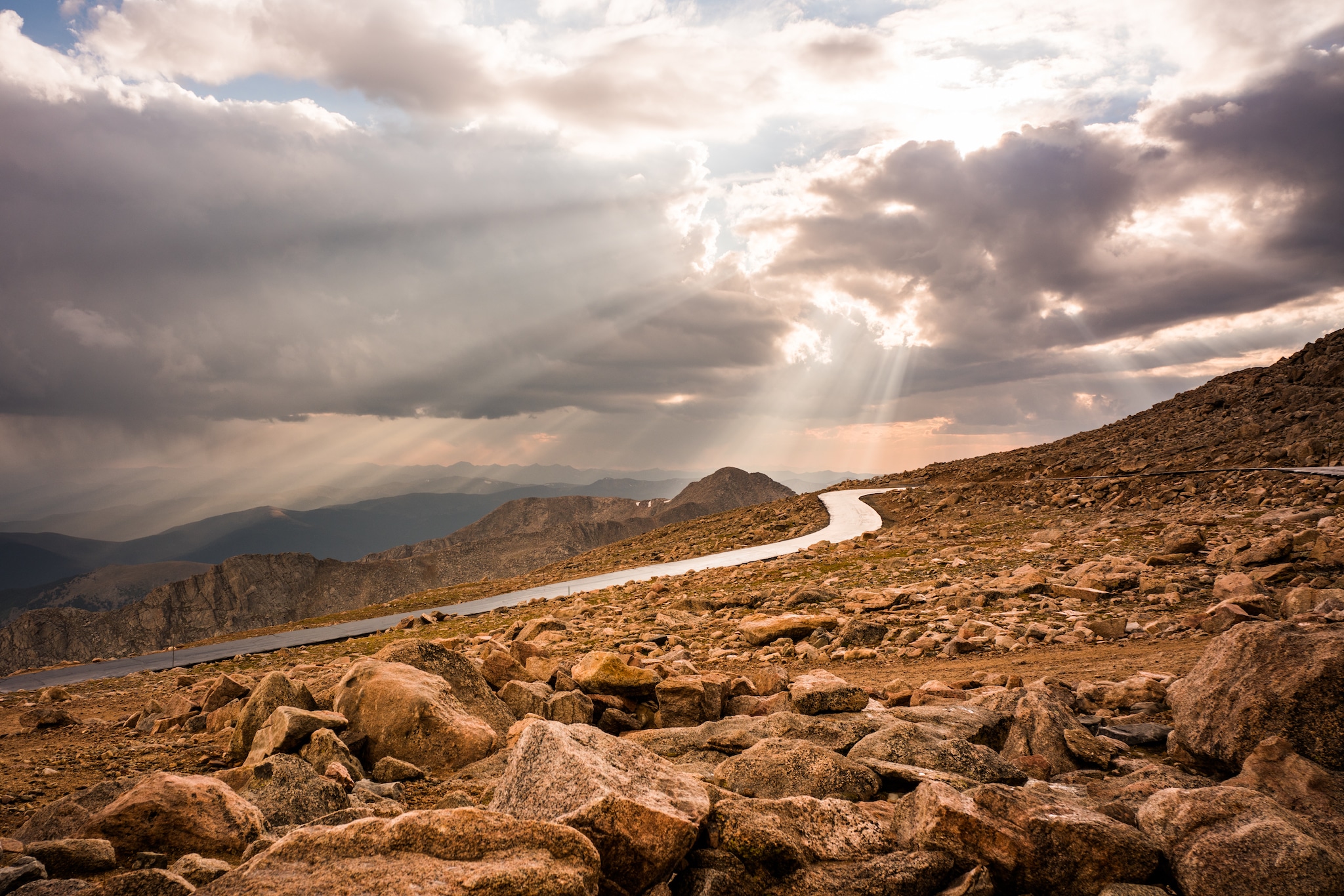 Sunlight streaming through the clouds on the Mount Blue Sky Road.