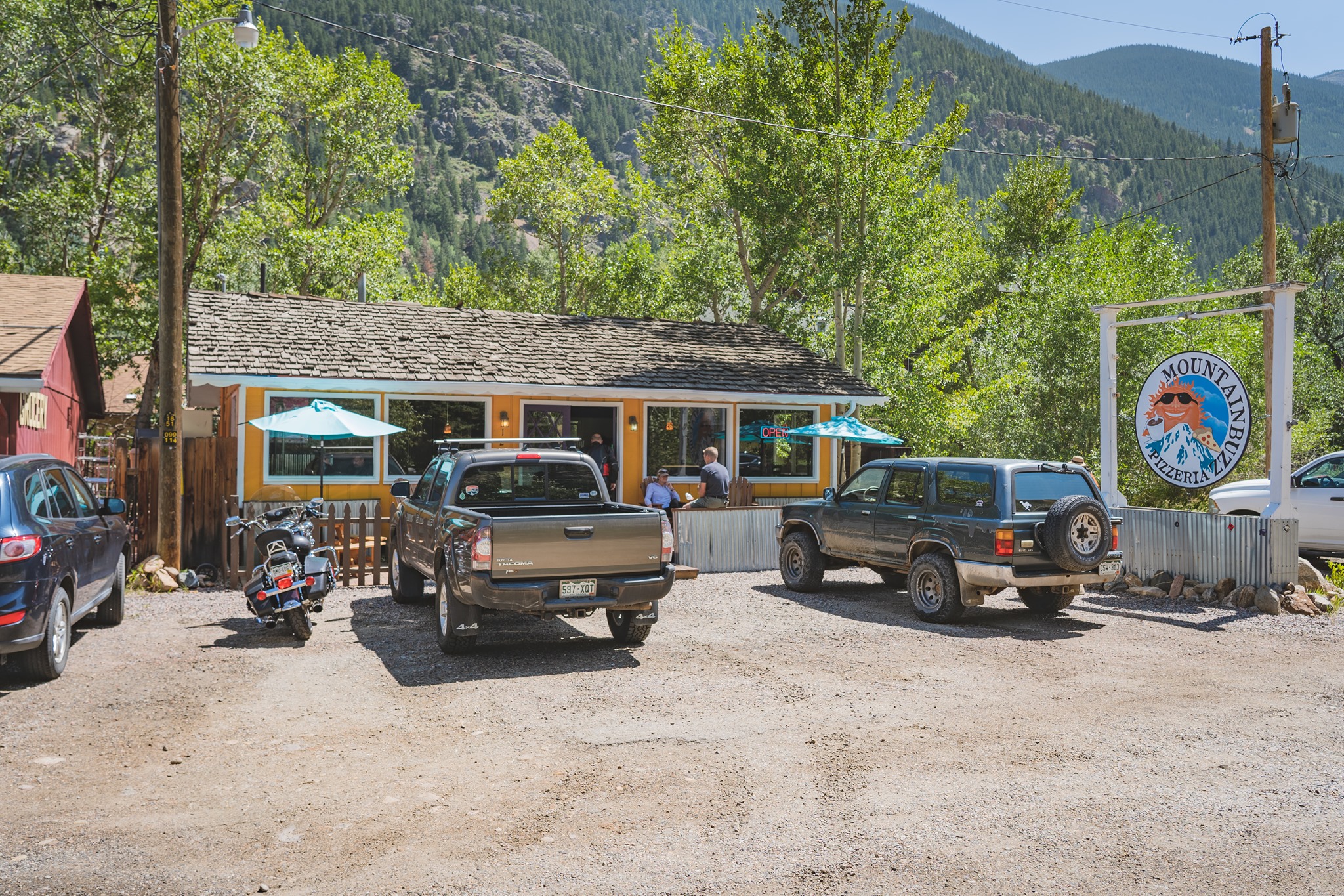 Pizzeria with trucks parked out front