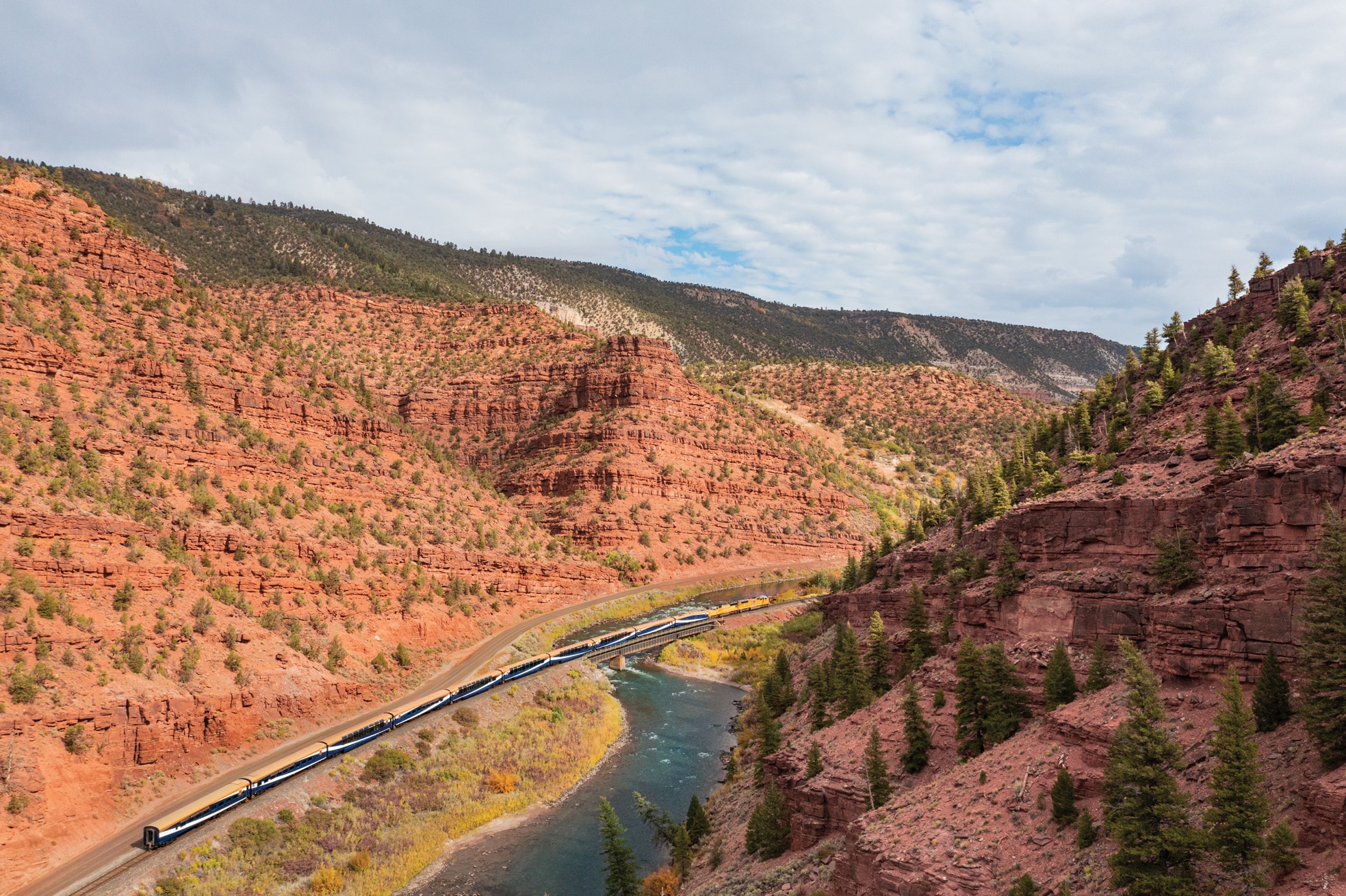 Passenger train in a red rock valley