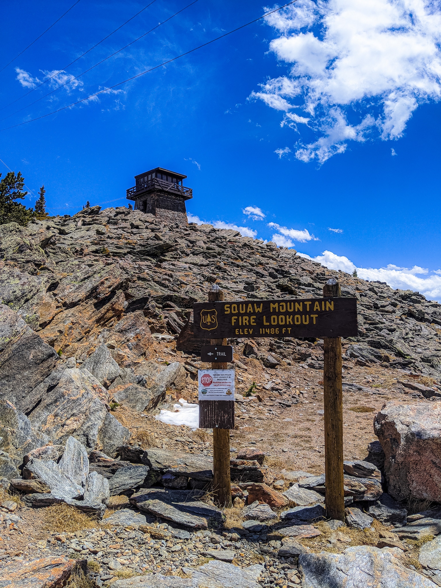 Squaw Mountain Fire Lookout sign with building in the back