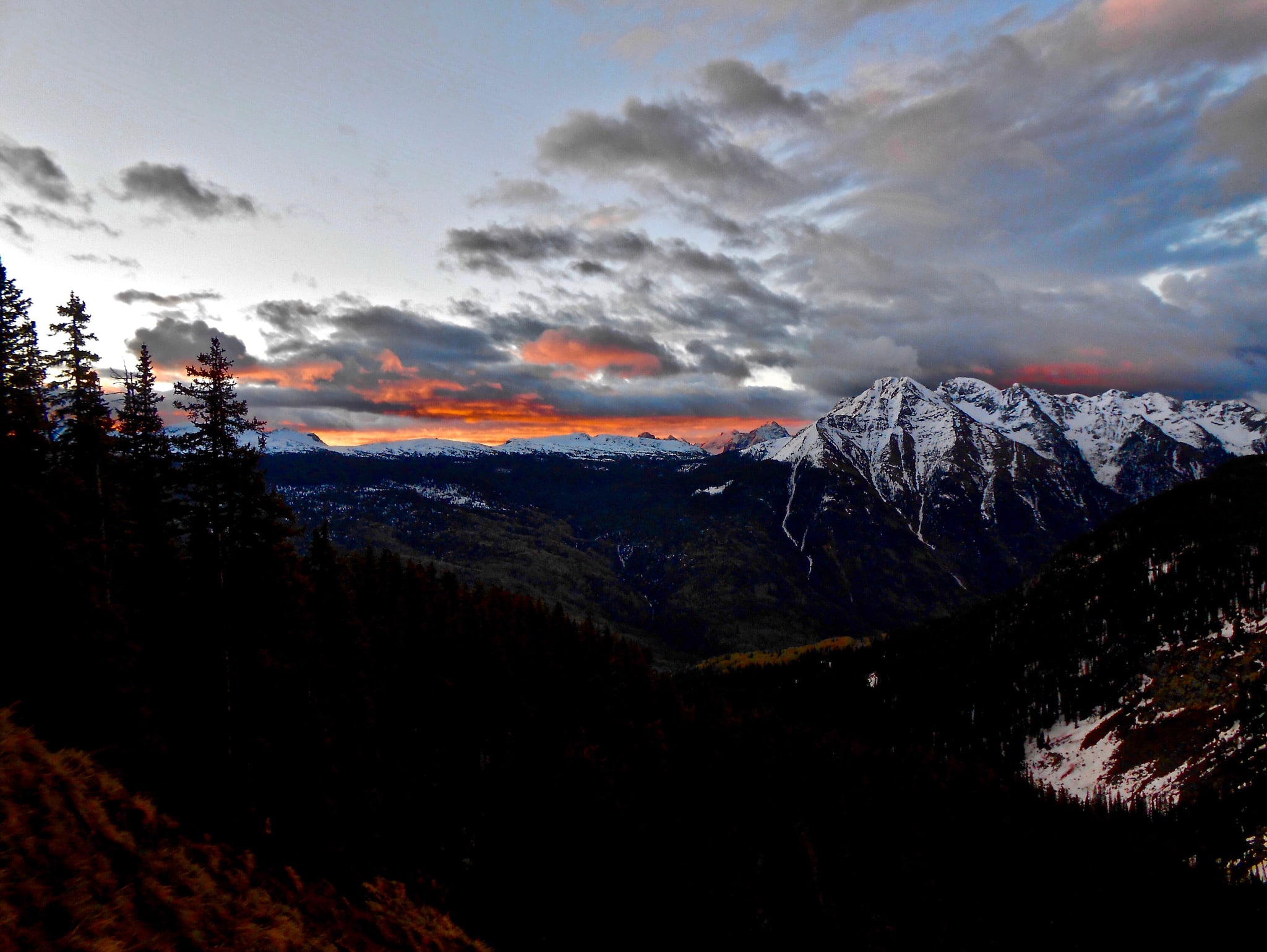 A red sunrise over the snow-capped Twilight Range in the San Juan National Forest.