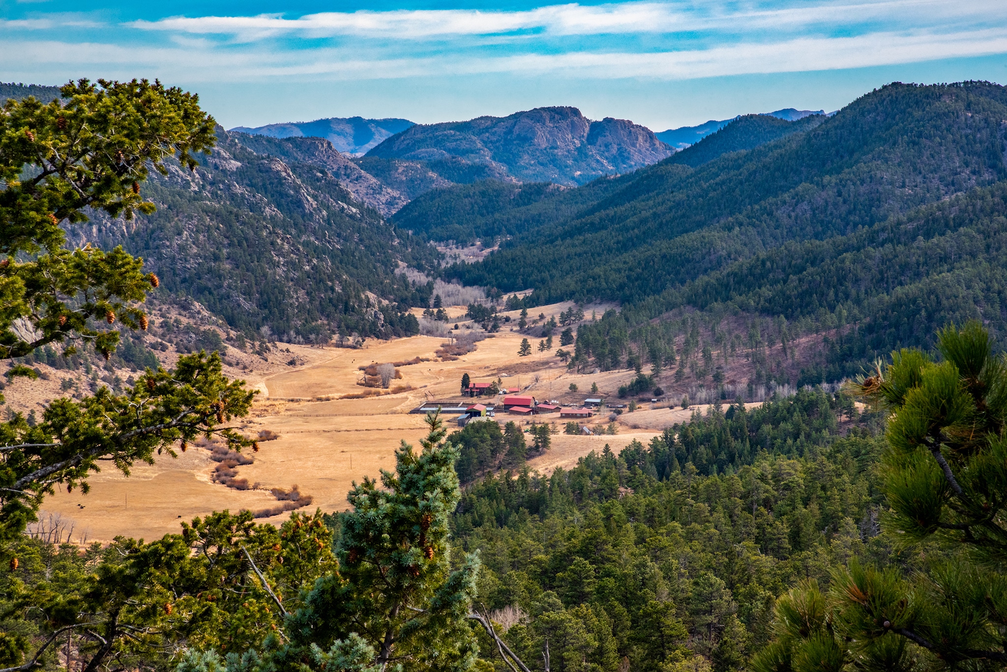 A sleepy ranch tucked between steep, rocky ridges in northern Colorado.