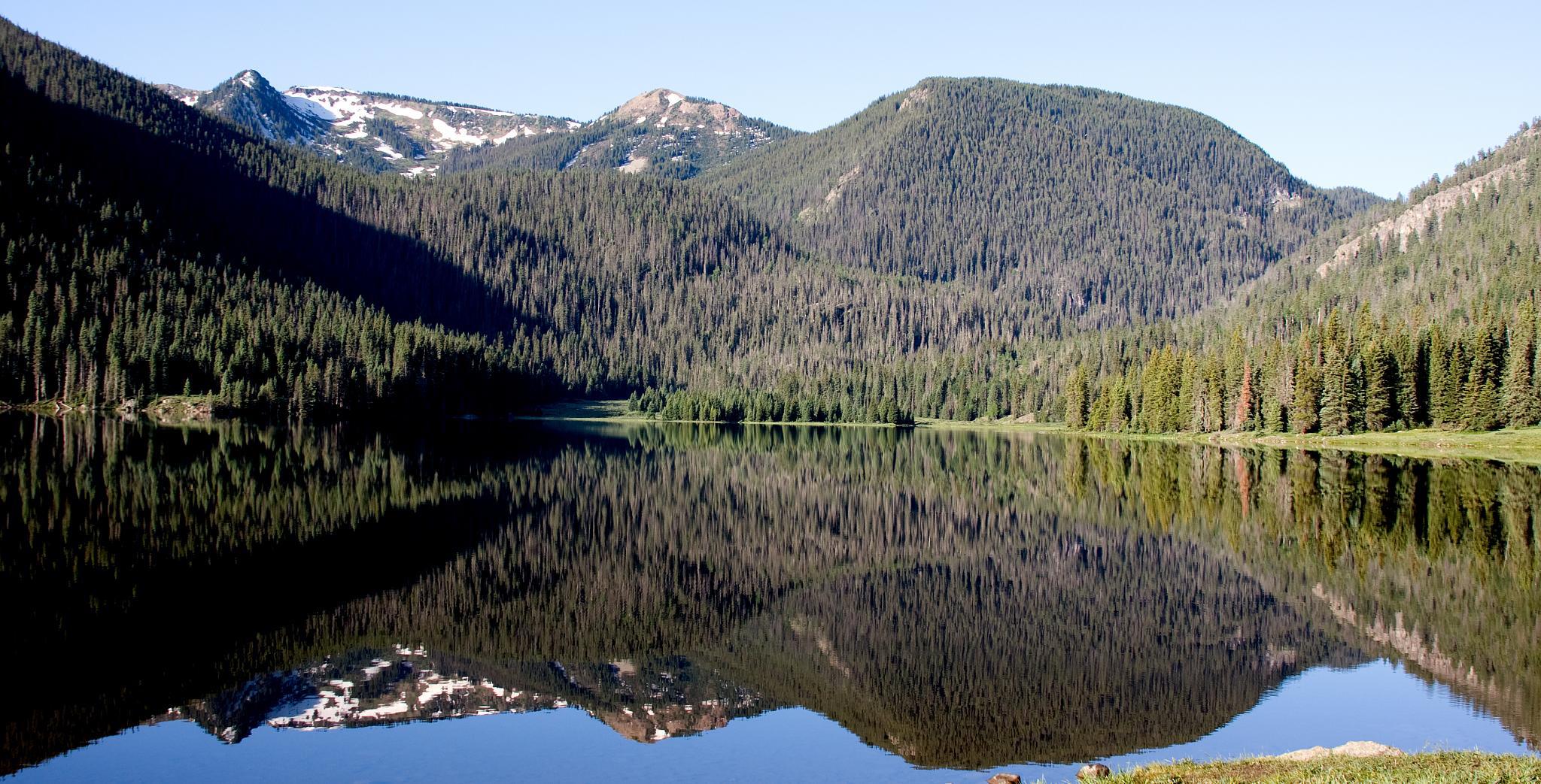 Tranquil waters of Big Meadow Reservoir in the Rio Grande National Forest.