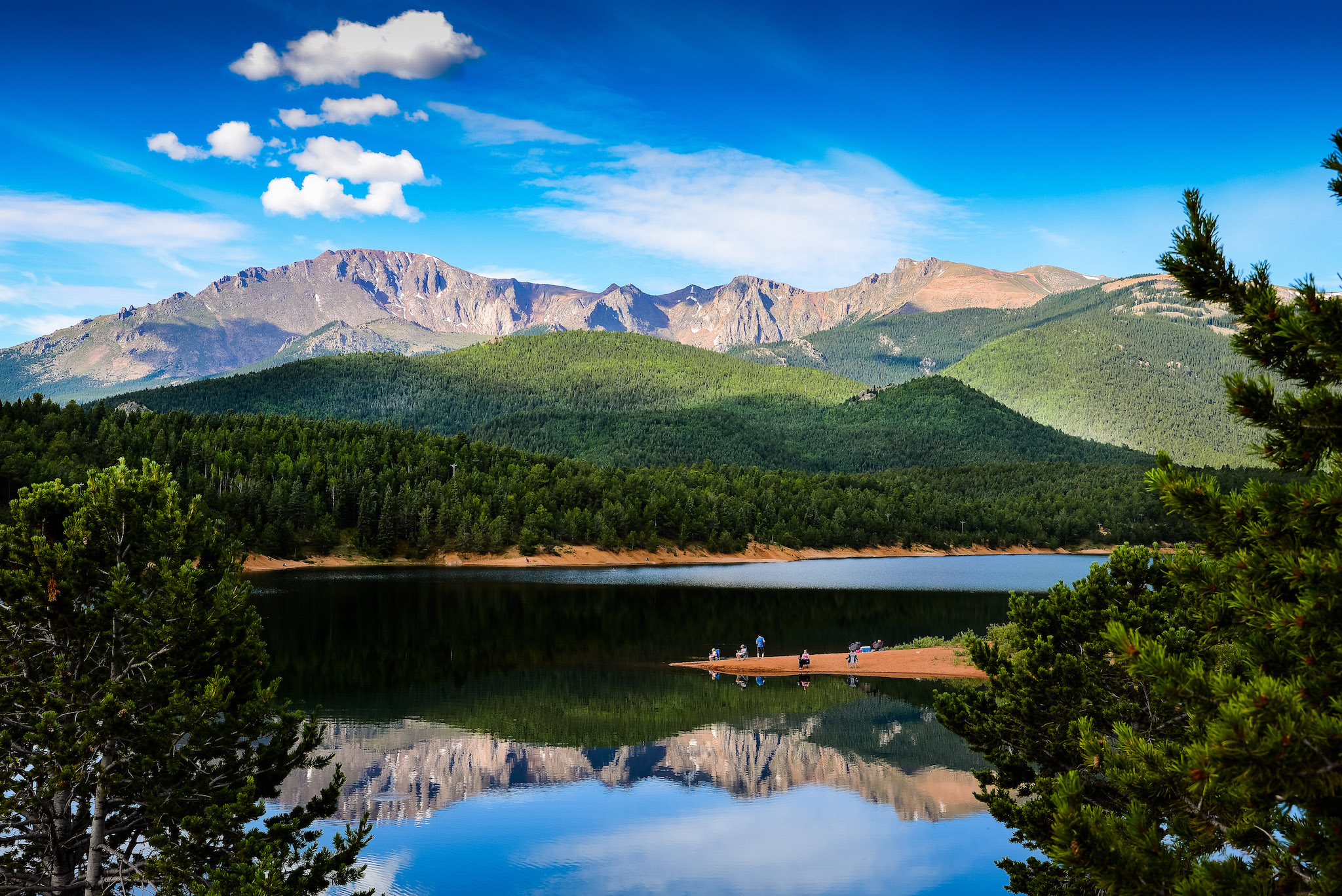 Crystal clear waters and looming mountains on a warm summer day.