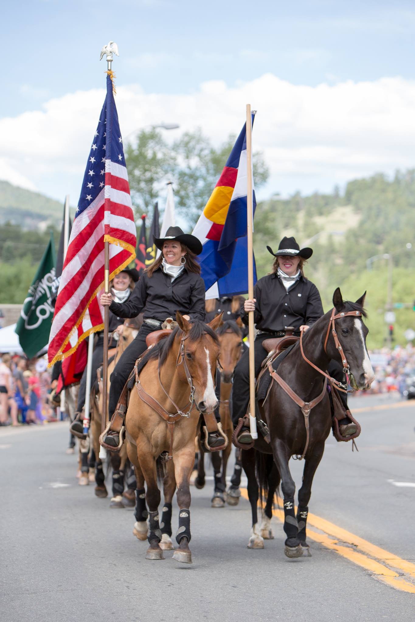 women on horses holding flags