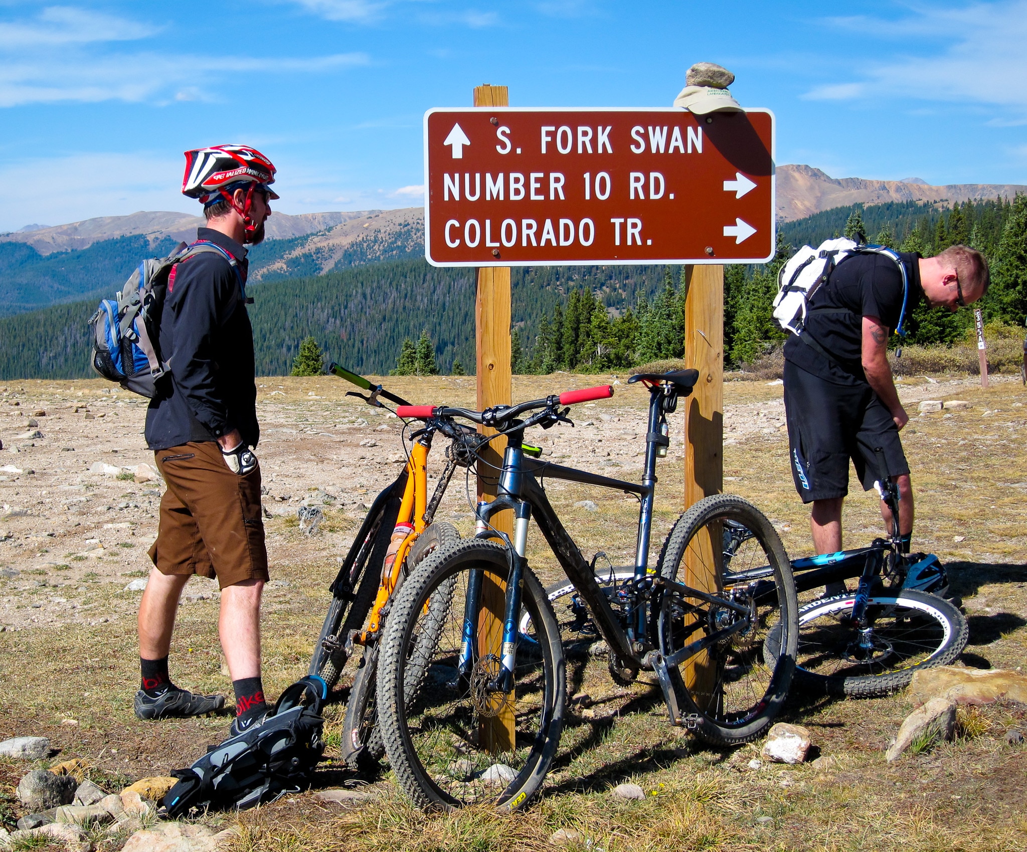 Two mountain bikers taking a break atop Georgia Pass on the Colorado Trail.