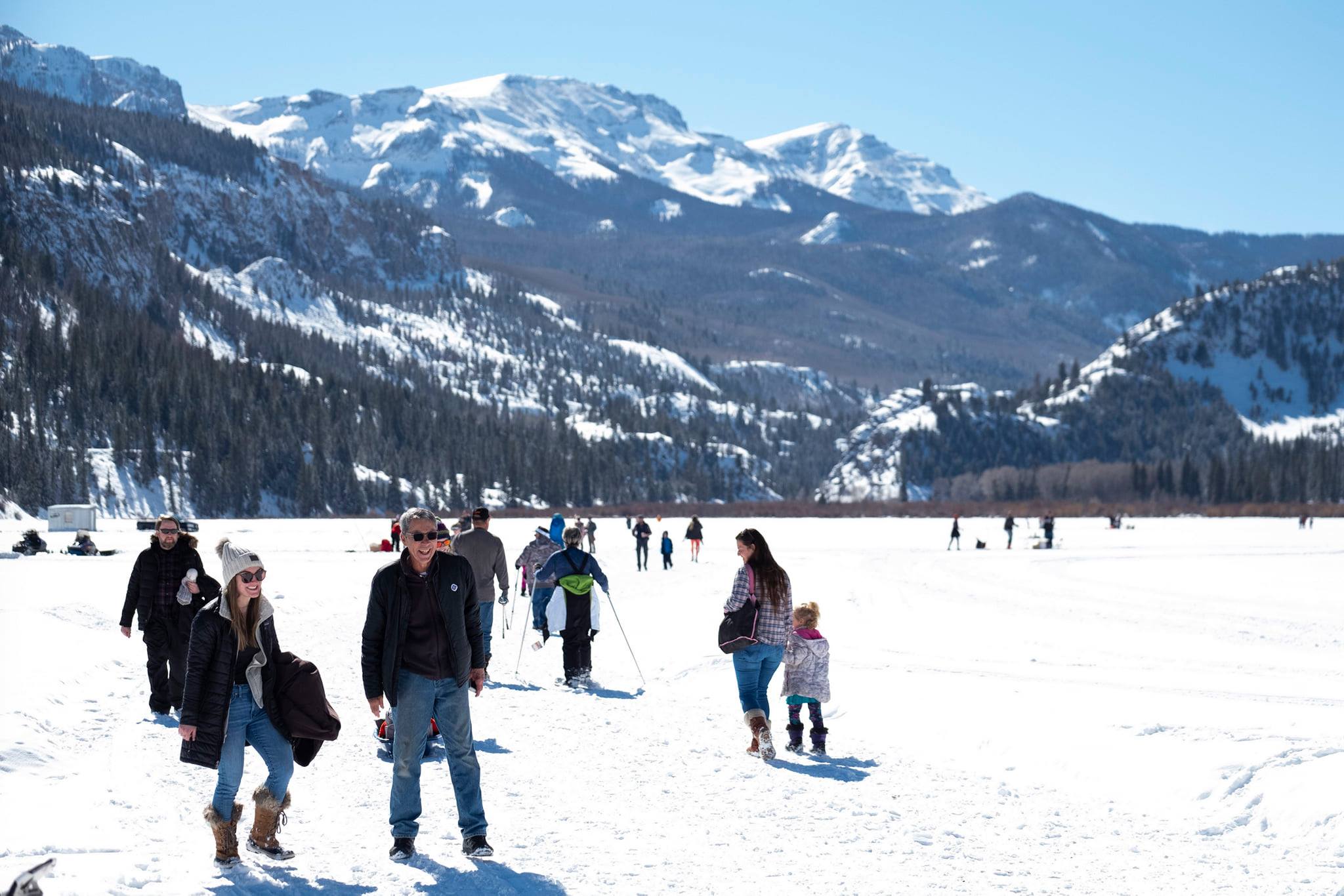 People on frozen snow covered lake