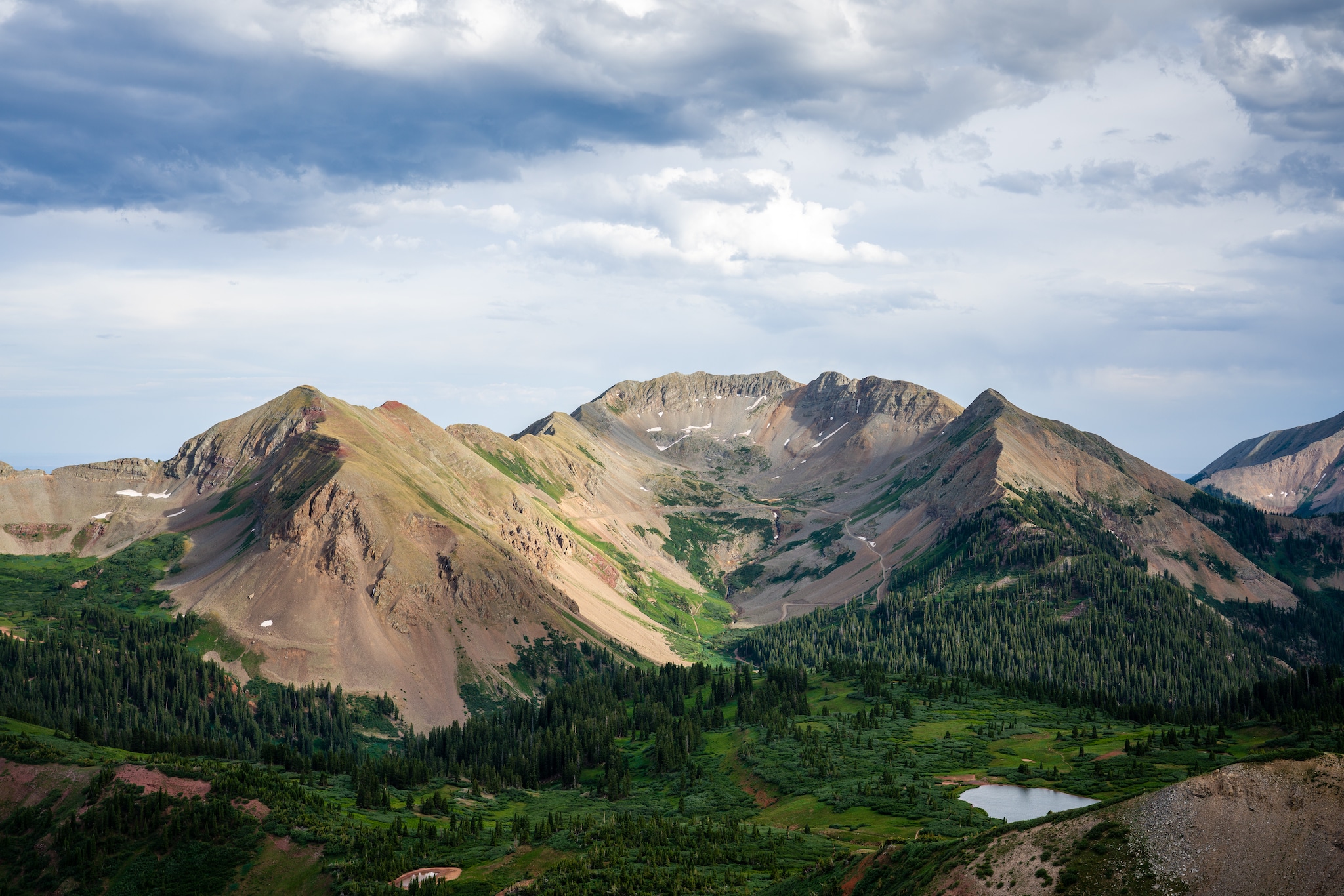 Verdant vegetation and alpine lakes beneath the towering La Plata Mountains.