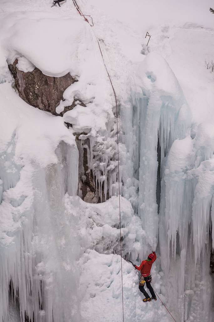 Climber on iced over waterfall