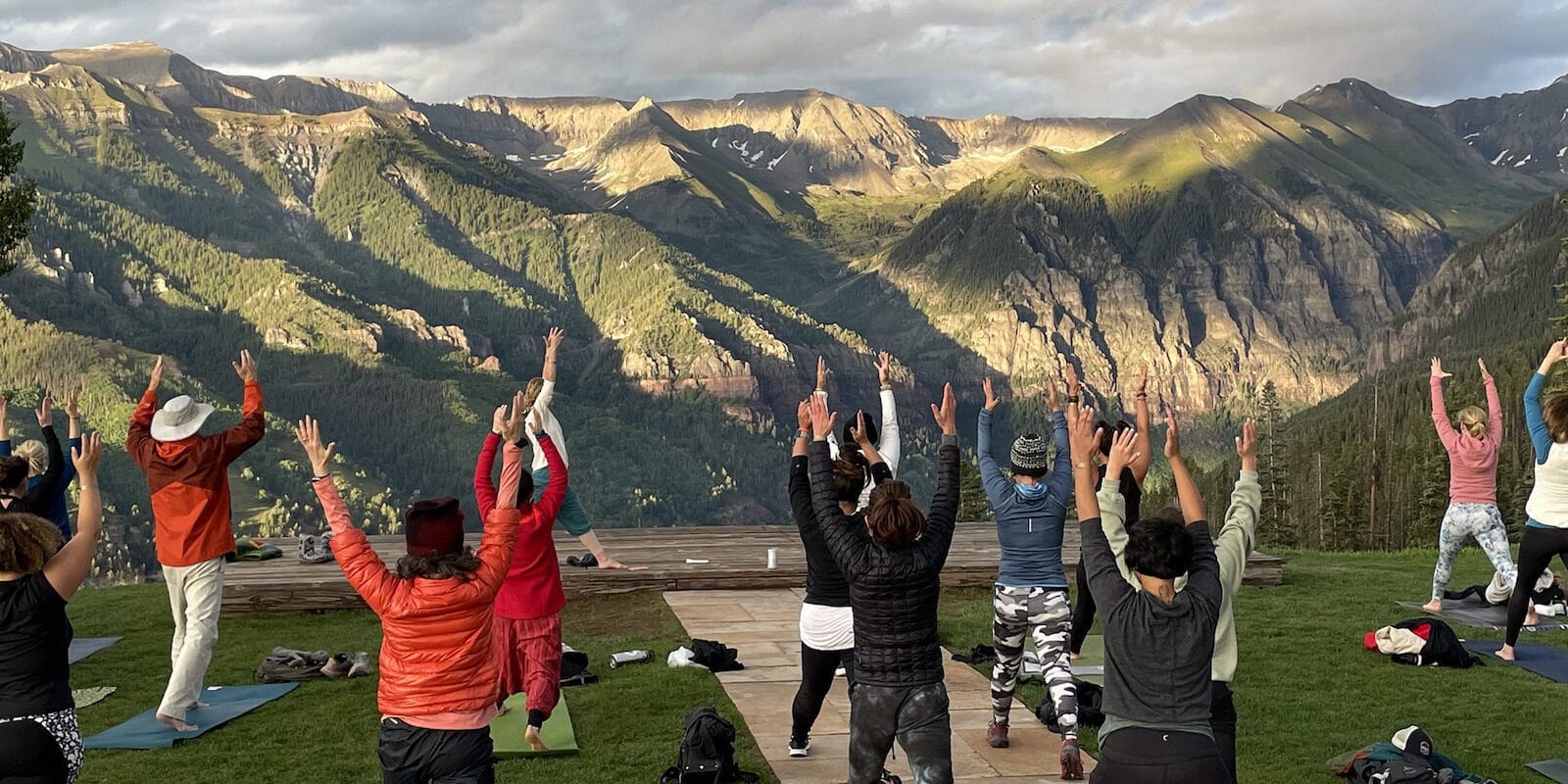 Image of people doing yoga looking out at the mountains at the Telluride Yoga Festival in Colorado