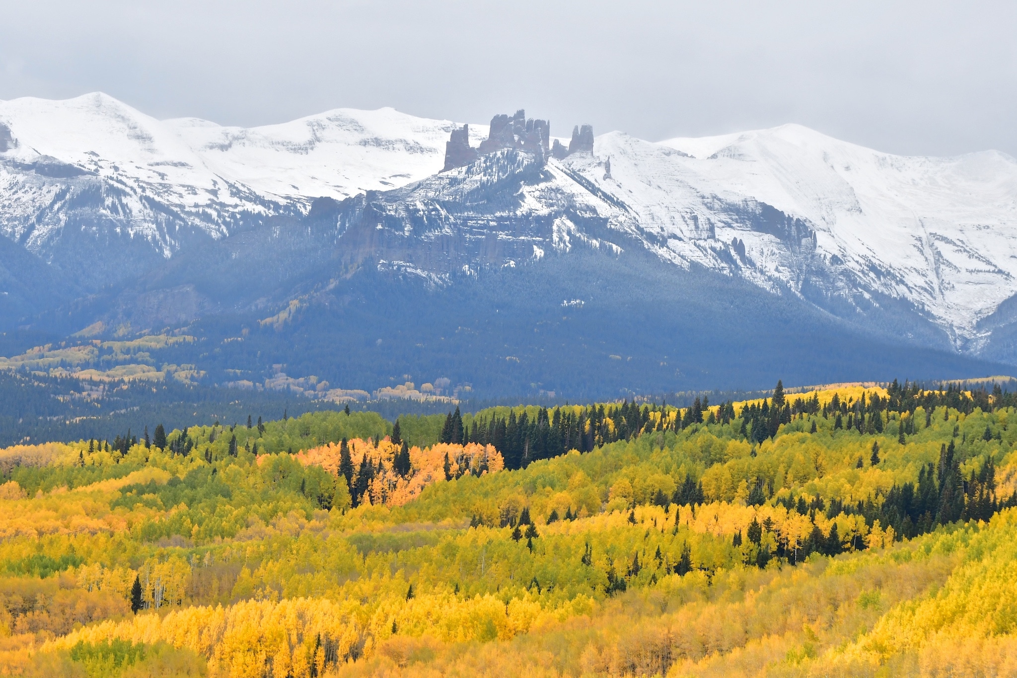 The West Elk Wilderness in autumn, with the Castles formation obvious against snowy slopes.