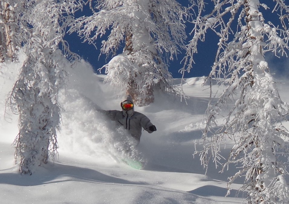 Snowboarder in fresh powder snow