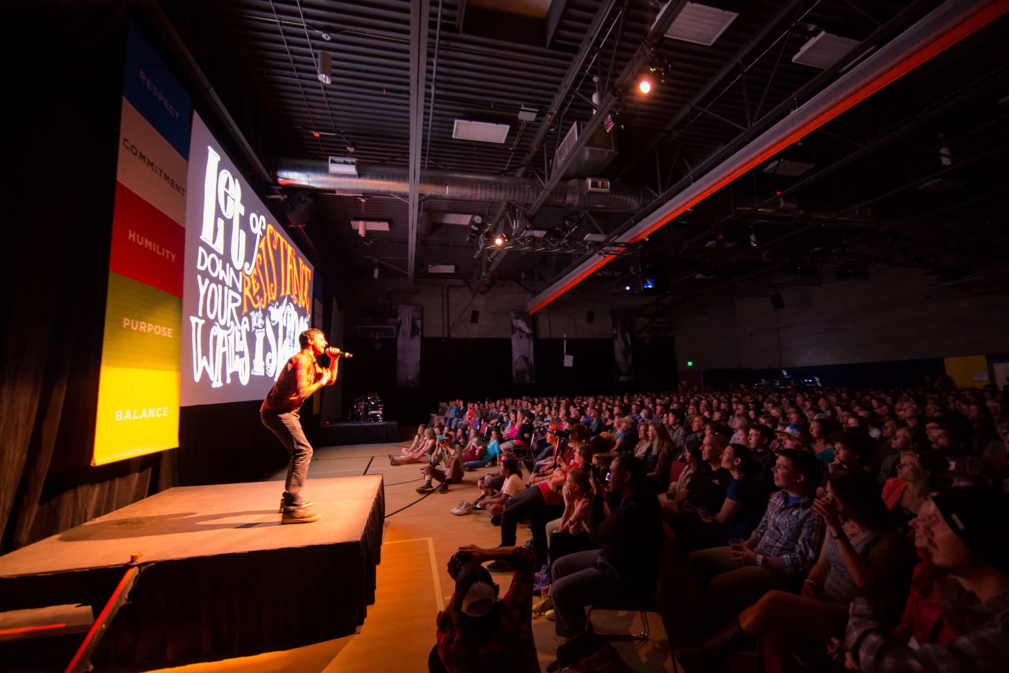 Presenter on stage at film festival in front of crowd