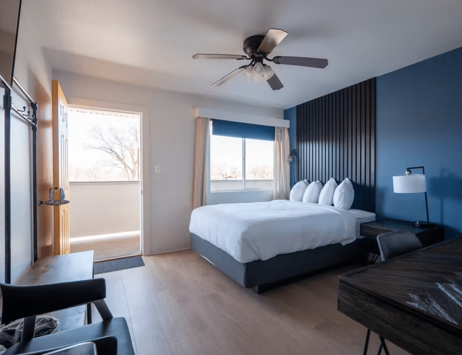 Hotel room with blue walls and black furniture