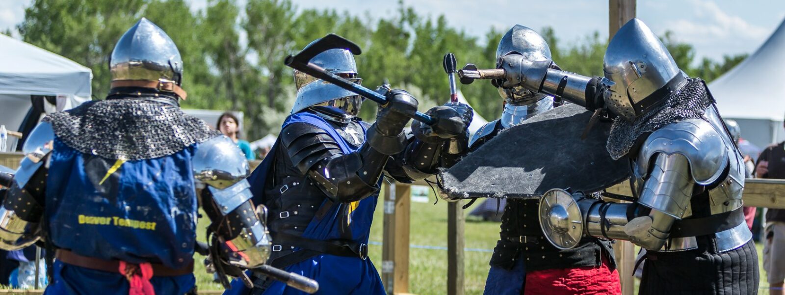 Image of people doing combat in armor at the Colorado Medieval Festival in Loveland