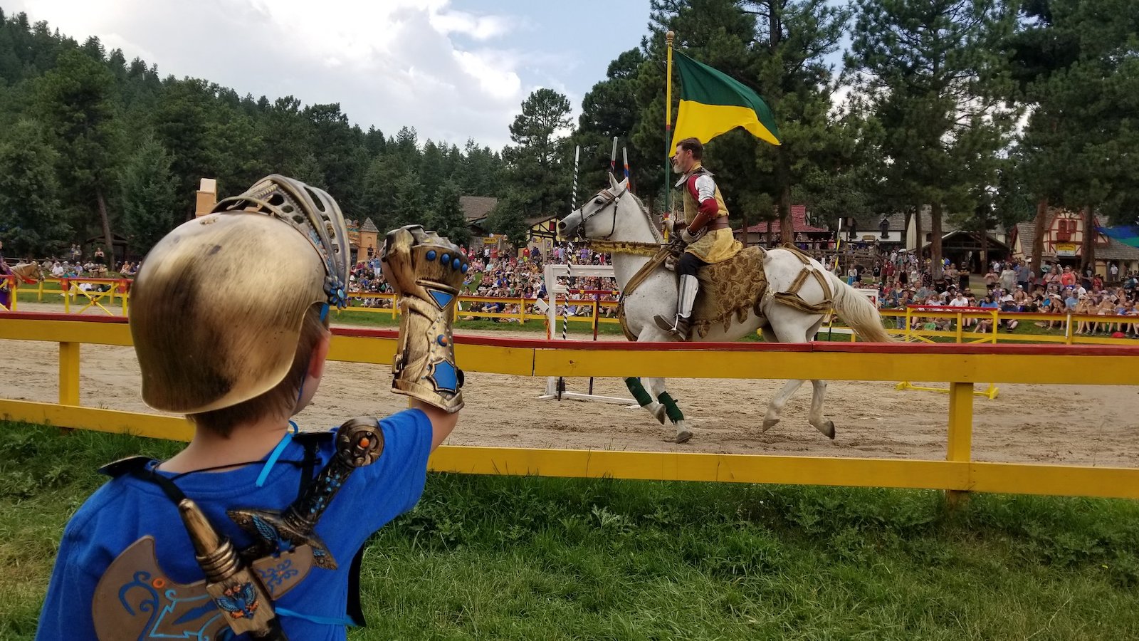 Image of a child watching a jousting event at the Colorado Renaissance Festival