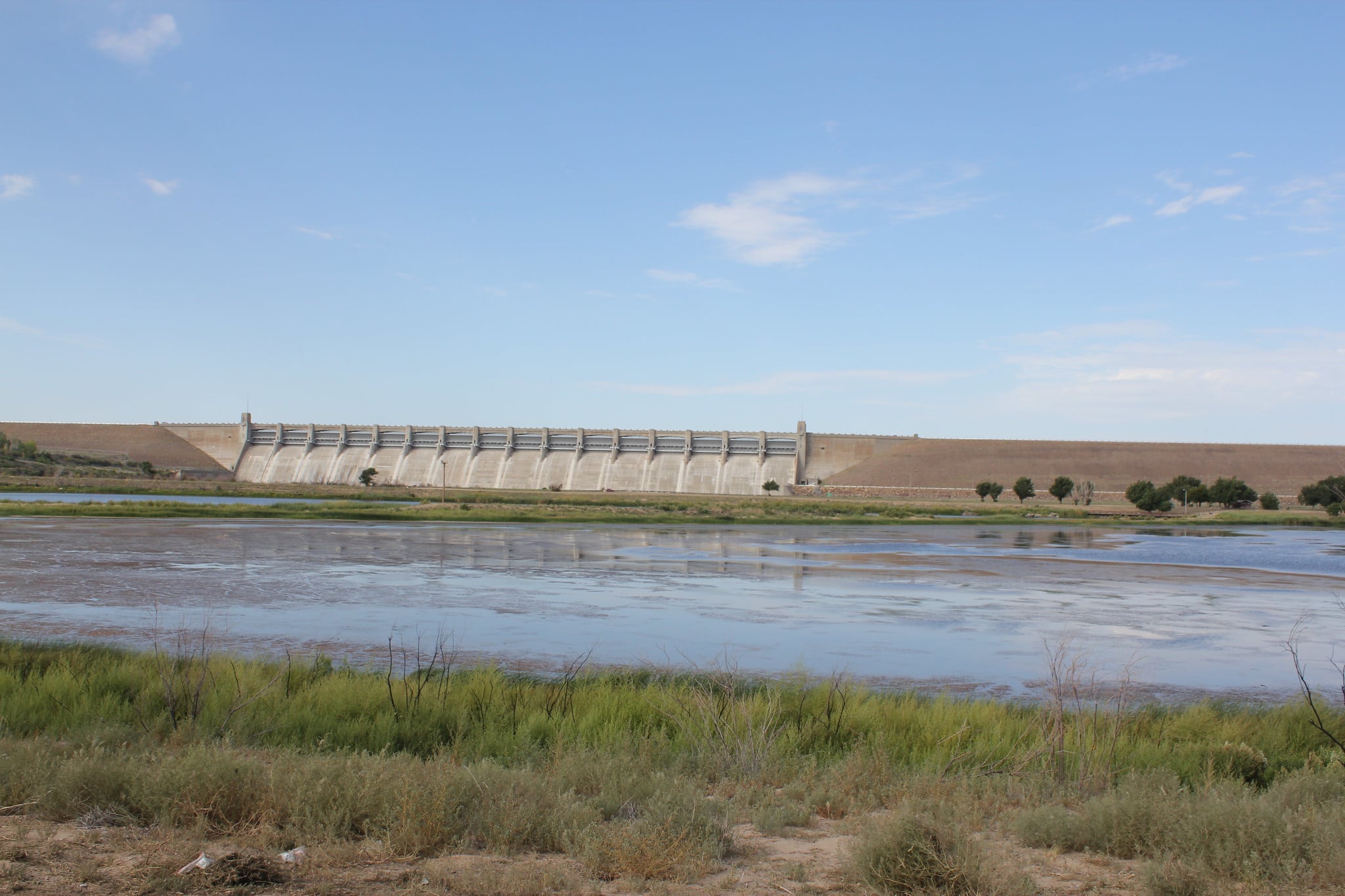 Blue skies over reservoir and dam