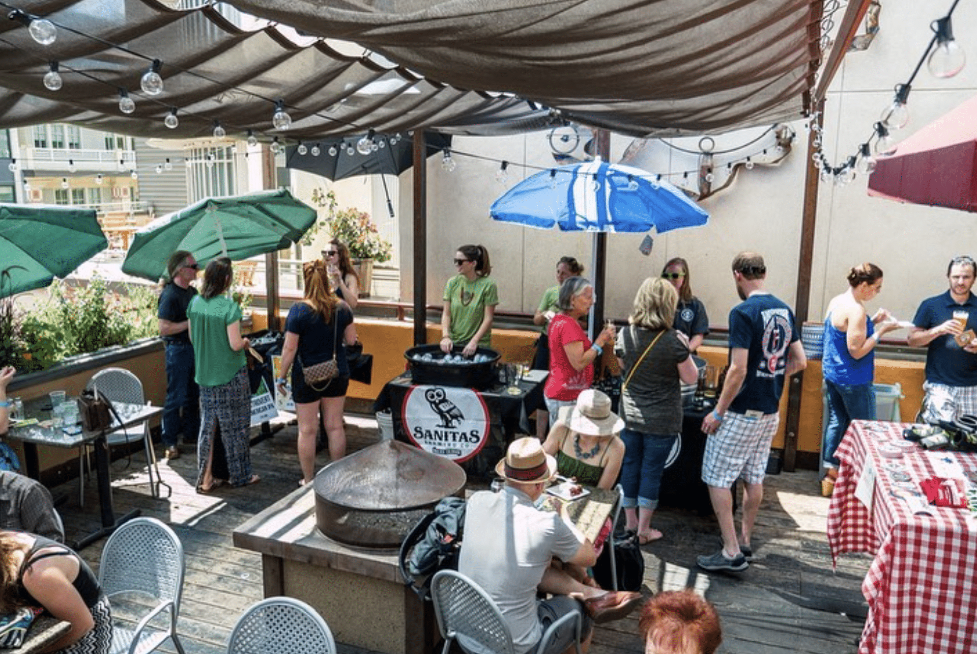 Patio at West End Tavern in Boulder filled with people enjoying craft beer during the JUL-IPA festival