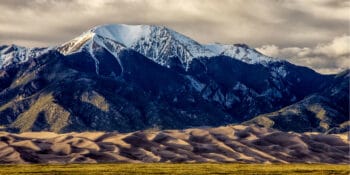 Sand dunes in front of mountains