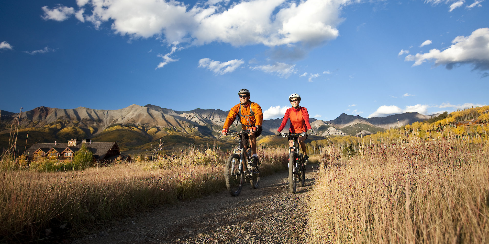 Two people on bikes on mountain trail