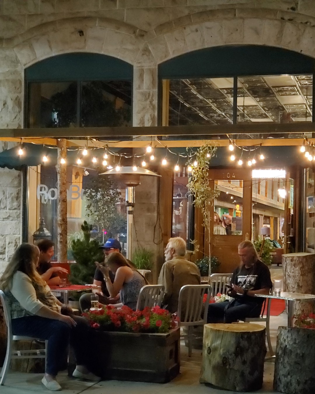 Outdoor patio at night with people talking