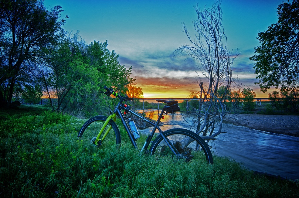 Bike in front of sunset over river