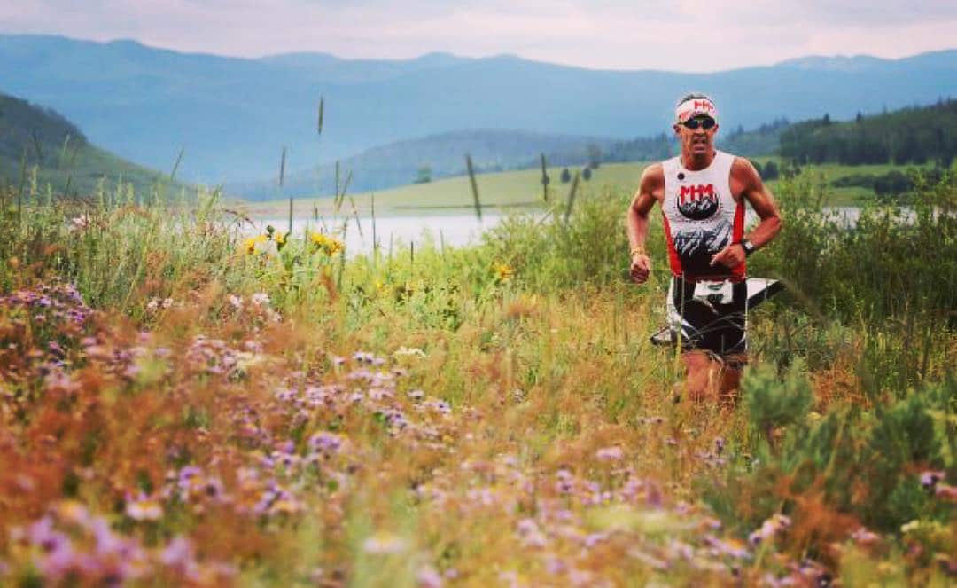 Triathlon runner in a meadow of flowers