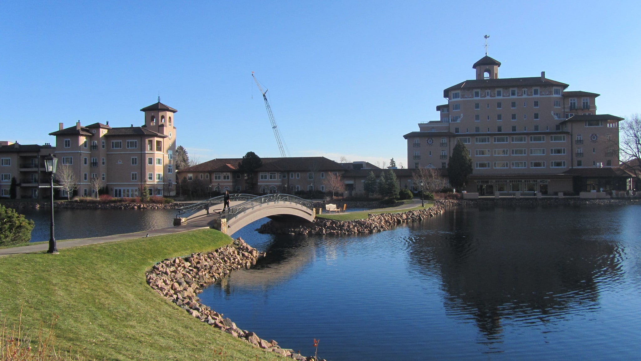 Lake with bridge leading to building