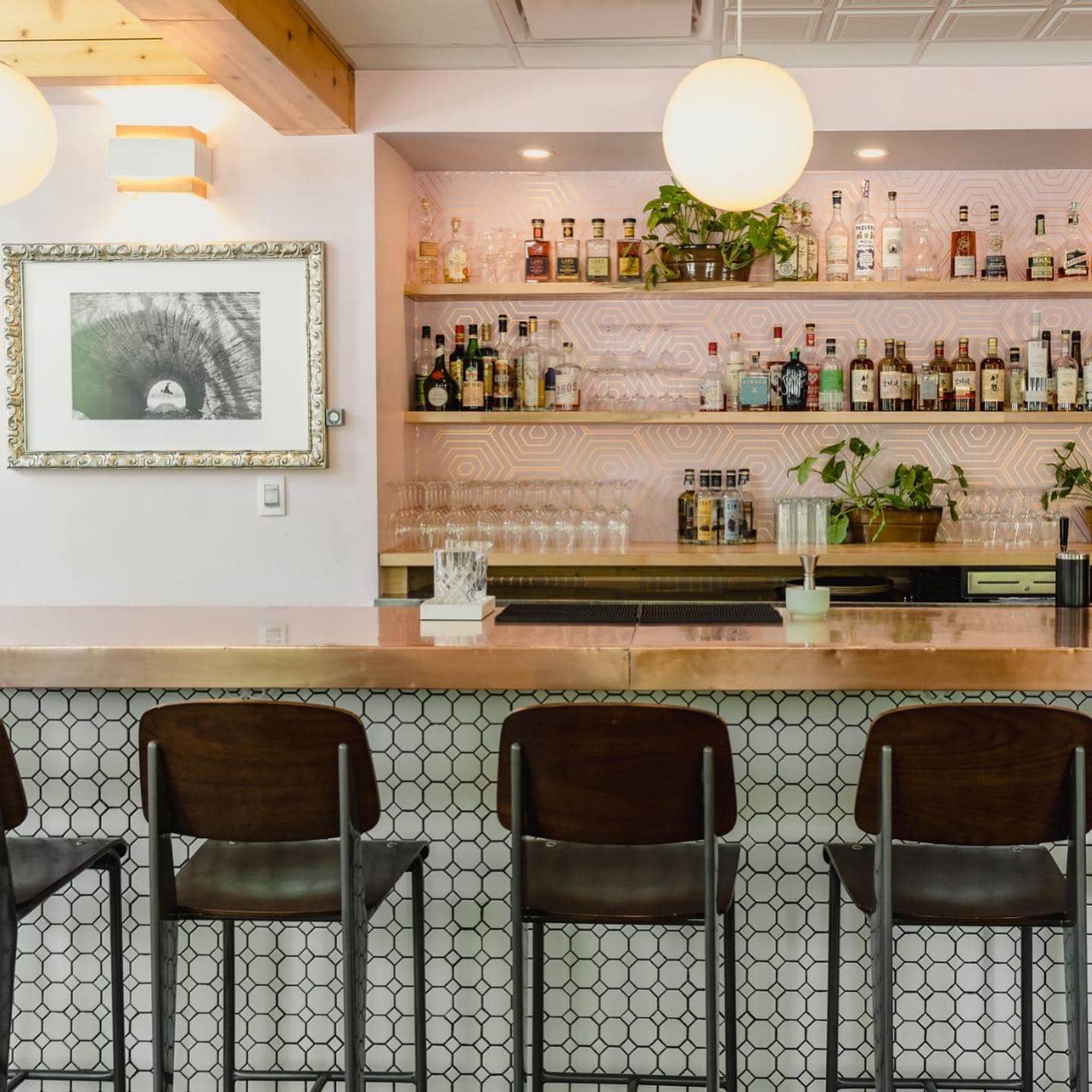 Modern bar seating with pink tiles