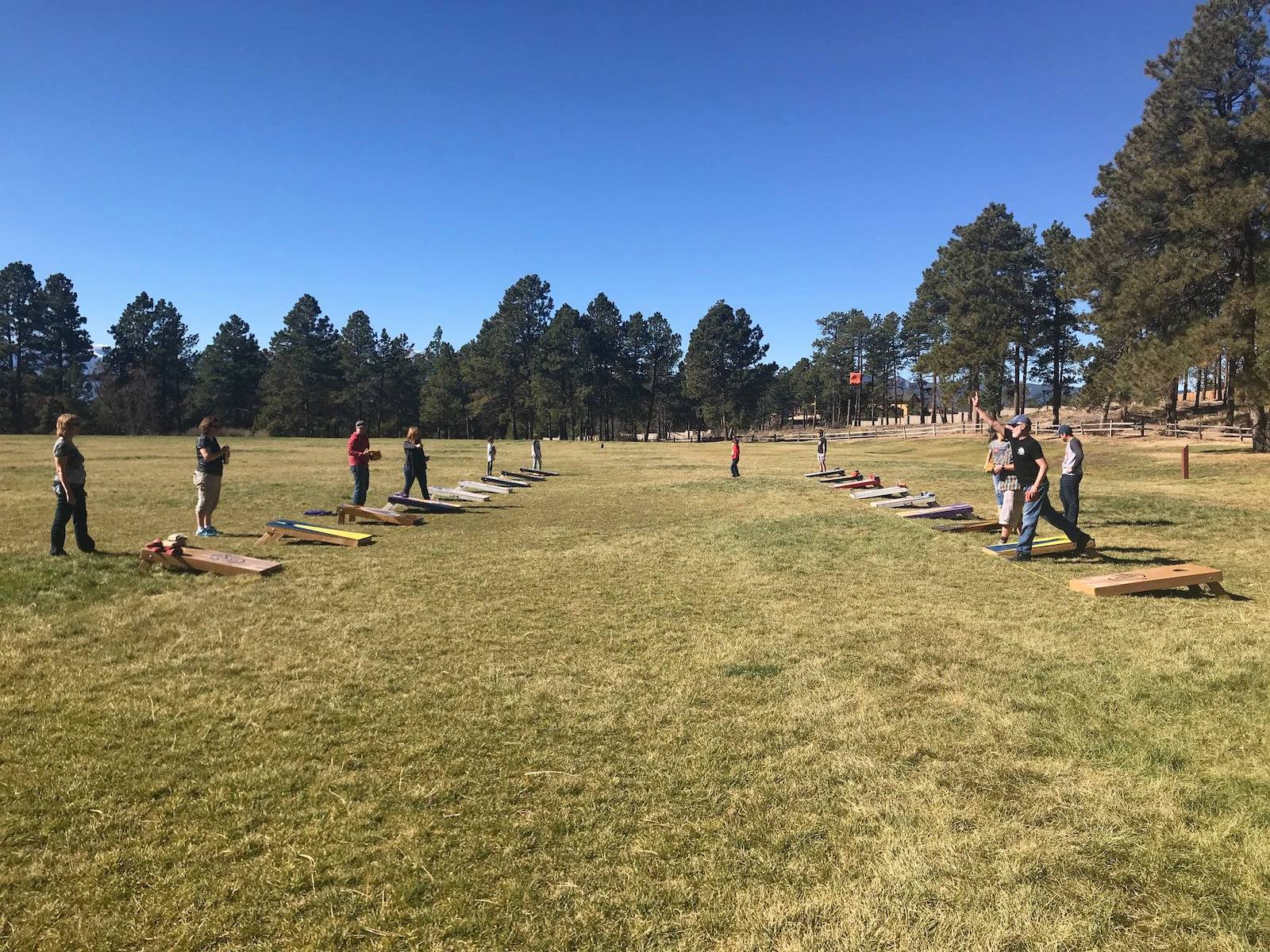 Image of people in a corn hole tournament at Black Forest Regional Park in Colorado Springs, CO