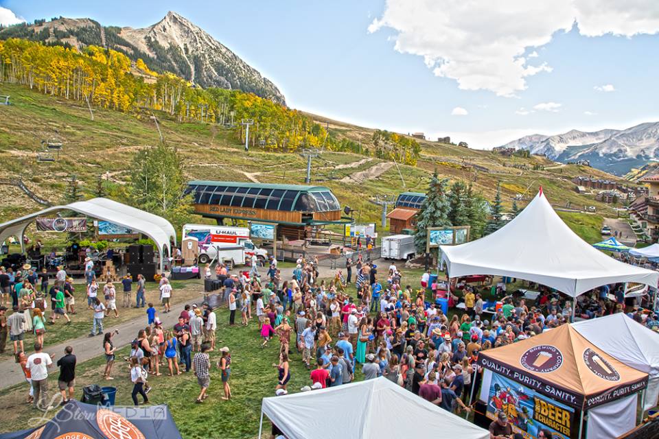 Crowds of people at a festival in the mountains