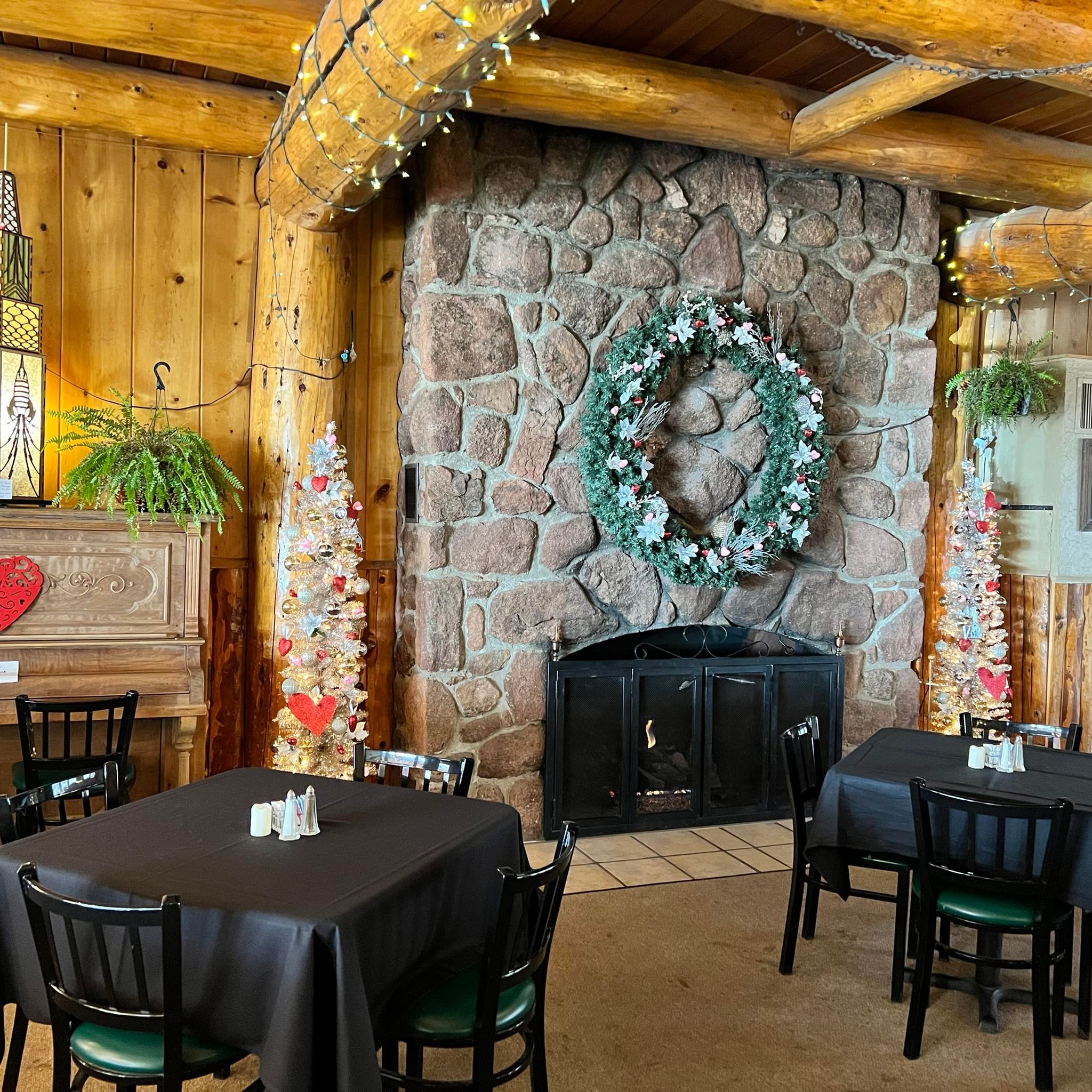 Inside of restaurant with big stone fireplace