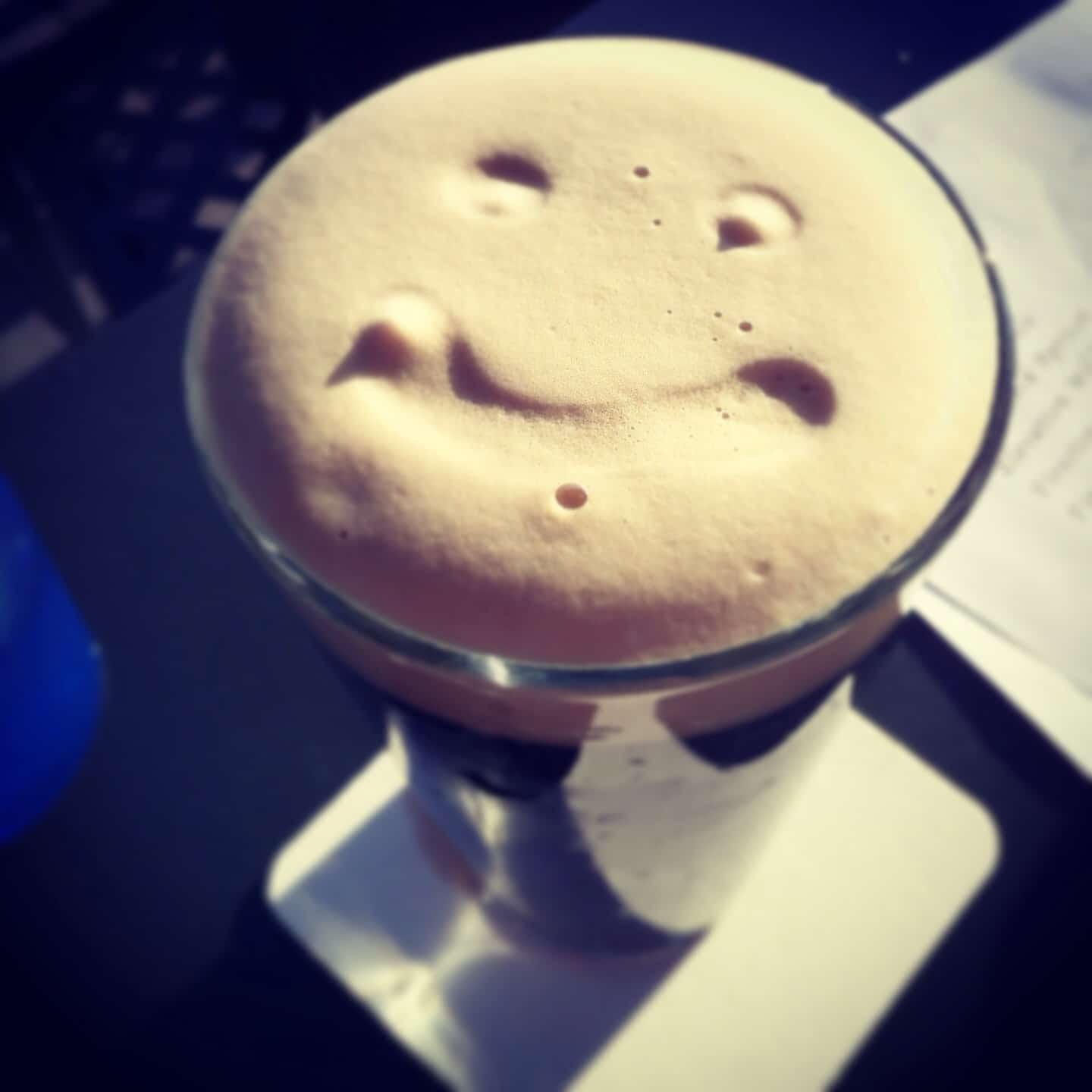 Left Hand Nitro Milk Stout beer with smiley face drawn into head fome