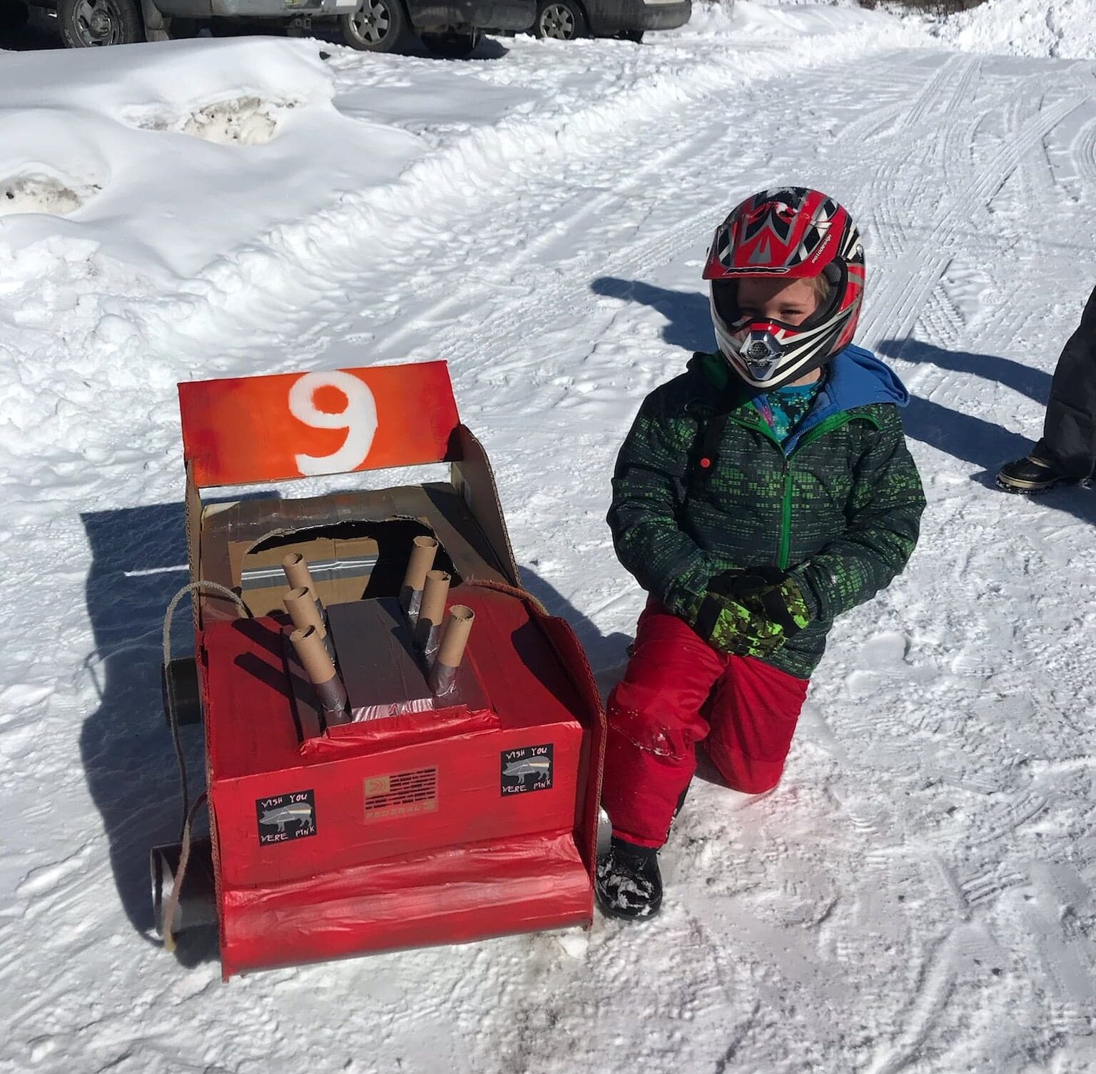 Cardboard sled and kid